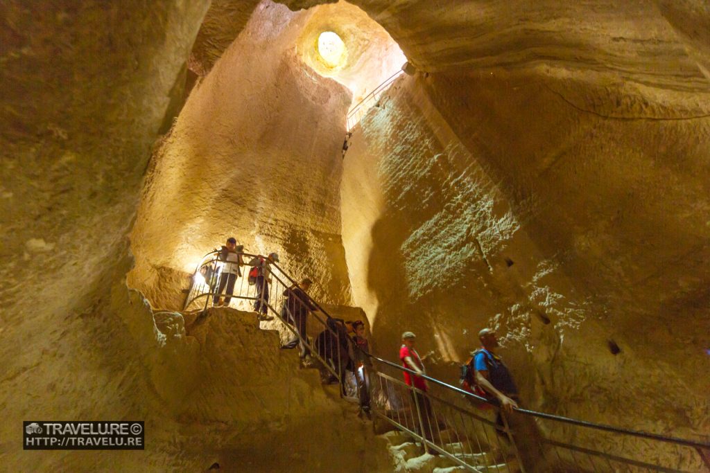 Visitors coming down the stairs cut along the side of the cave at Bet Guvrin-Maresha Caves Israel - Travelure ©