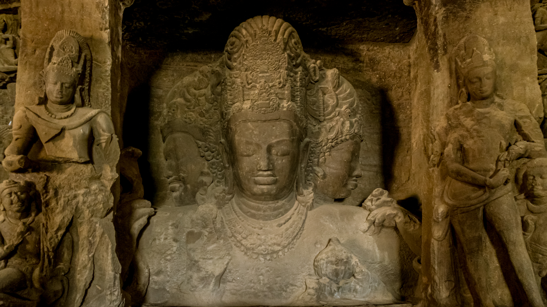 Trimurti — three-headed Shiva sculpture, Elephanta Caves Cave 1, Mumbai Harbour, Maharashtra — 5th-6th century CE rock-cut basalt, UNESCO World Heritage Site.